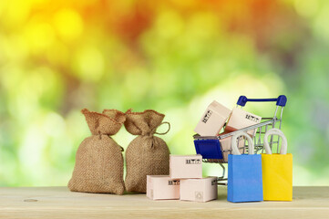 paper shopping bags and boxes in trolley on green yellow background Customer can buy everything from office or home Shopping online concept.