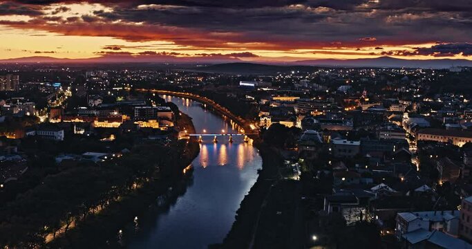 Aerial shot: Incredible sunset over the city Uzhhorod and river Uzh. 4k