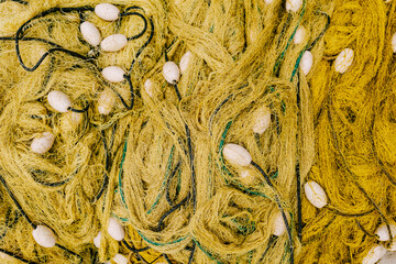 Yellow fishing net with floats. Close-up