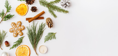 Christmas Banner. winter, new year composition. Christmas frame made of Fir tree branches, cinnamon sticks, candies, gingerbread on white background. Flat lay, top view, copy space