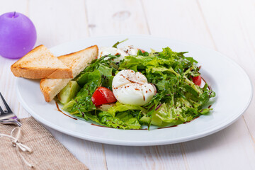 fresh salad with arugula, tomato and egg