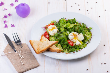 fresh salad with arugula, tomato and egg