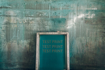 Screen printing film in workshop standing against the green background
