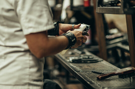 Professional Barber Holding A Hair Trimmer In Her Hands