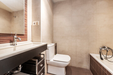 Toilet with white sink and black furniture in vacation rental apartment