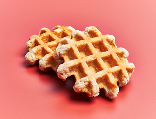  Two delicious waffles over red background