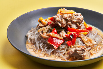  Plate of delicious rice noodles over yellow background