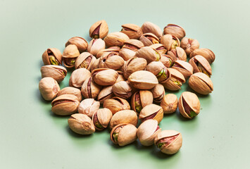  Bunch of pistachios over green background
