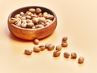  Bowl of pistachios over yellow background
