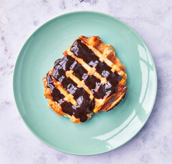  Plate of delicious waffle with chocolate on marble surface