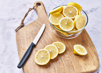  Bowl of slices of lemon on a marble surface