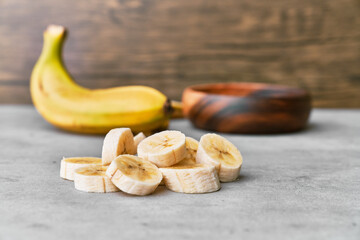 Photo of banana slices on a concrete surface