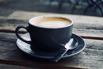 cup of coffee on wooden table