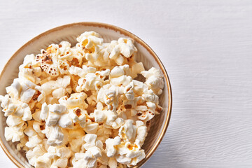 Bowl of salty popcorns isolated on a white background