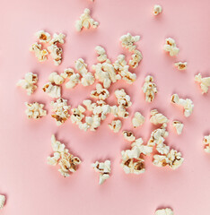  Bunch of salty popcorns on a pink background