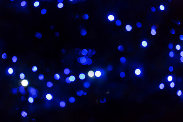 Blue-colored lights on the background. The whole shot is strong defocused to use bokeh simulation