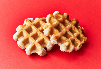  Two delicious waffles over red background
