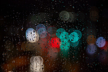 rainy days.rain drops on the window and traffic bokeh in distance