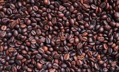 Brown and black coffee beans. Roasted arabic espresso coffee grains.