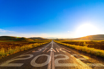 2022 start. 2022 new year concept idea. happy new year. road at sunrise.
