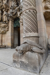 Barcelona, Spain - 22 Nov, 2021: Carved turtle at the base of a column supporting the facade of the Sagrada Familia, Barcelona, Catalonia, Spain