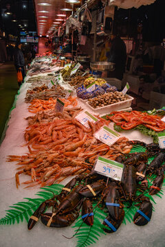 Barcelona, Spain - 23 Nov, 2021: Fresh fish and seafood on sale on a market stall in the Mercat de la Boqueria, Barcelona, Spain
