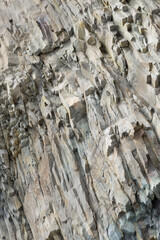 Sheer cliff, cave entrance.