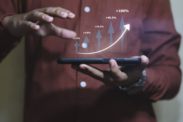 Business man holding tablet and showing holographic graphs and stock market statistics gain profits. Concept of growth planning and business strategy.