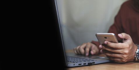 young man working on laptop in modern kitchen, checking email in morning, writing message in social network, happy young male using internet banking service, searching information