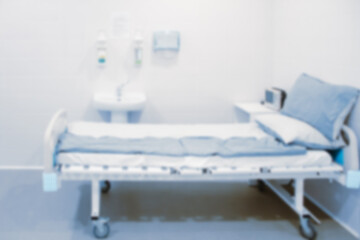 Blurred photo of the operating room in a hospital. Surgical equipment with operating table. Medical device for emergency patient in blue tone style. Blank Surgery Room. Clinic interior for background.