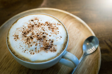 Cappuccino or latte coffee with frothy foam, coffee cup top on wooden classic vintage style coffee time