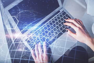 Double exposure of woman hands working on computer and world map hologram drawing. Top View. International business concept.