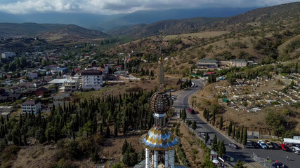 Cross on the spire of the Church of St. Nicholas lighthouse Crimean memorial to the victims on the...