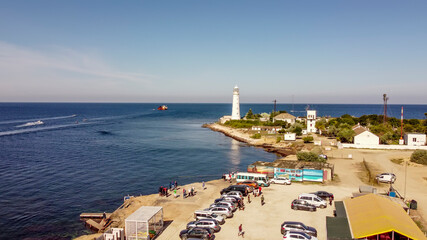 Seascape with beautiful white lighthouse on Cape Tarkhankut, Crimea.