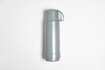 Plastic thermos isolated on white background.Thermos flask with cup.High resolution photo.Top view....