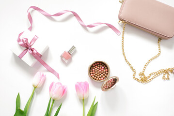Valentine's Day, Mother Day, spring Concept with pink tulip flowers, bag, mobile phone and cosmetics. Top view. The view from the top. Trending concept for a blogger
