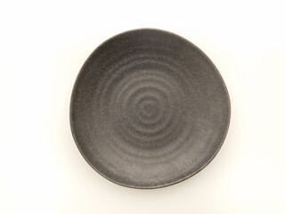 Fototapeta na wymiar Top view of empty black ceramic plate isolated on a white background