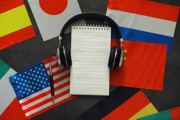 Learning foreign languages. Audio language courses. Background from countries flags and headphones...