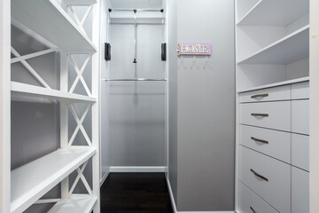 Emplty closet for storing of clothes in brdroom. Shelves and two level clothes rods are built in