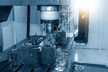 The CNC milling machine cutting the  mold parts with oil coolant method.