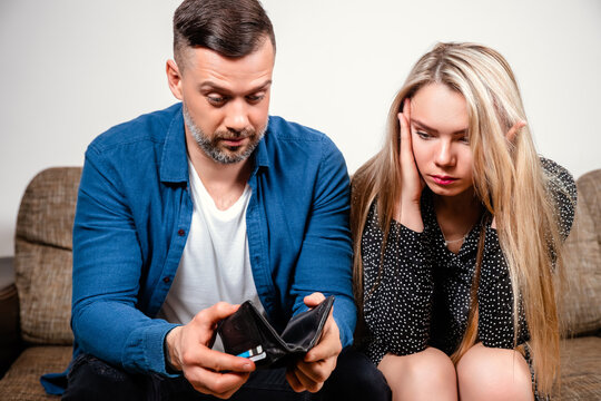 Depressed Young Couple Having Bad Headache Feeling Desperate In Bad Financial Situation By Lack Of Money To Pay Out Debts With Credit Cards.