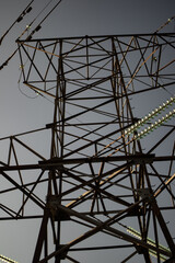 High voltage tower with power lines. View from bottom to on the top of tower's voltage