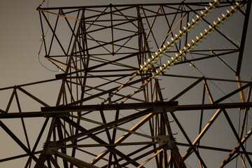 High voltage tower with power lines. View from bottom to on the top of tower's voltage