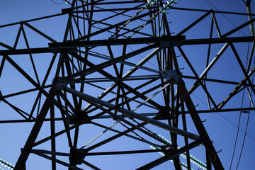 High voltage tower with power lines. View from bottom to on the top of tower's voltage