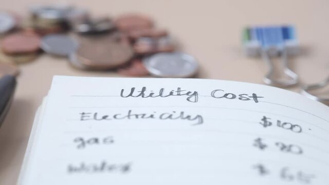 list of utility bills on a paper on table 
