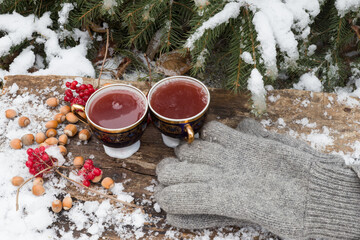tea in a cup on a blackboard in the snow