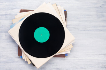 many vinyl records in paper packaging lie on a gray background