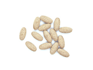 A handful of brown pills. Tablets or vitamins isolated on white background. Dietary supplements or Biologically Active Additives Tablets, BAA. Top view.