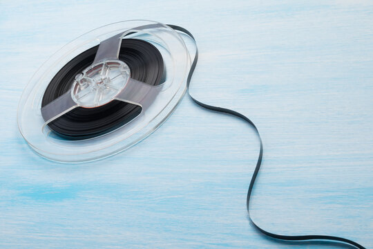 magnetic cassette with unwound tape on a blue background