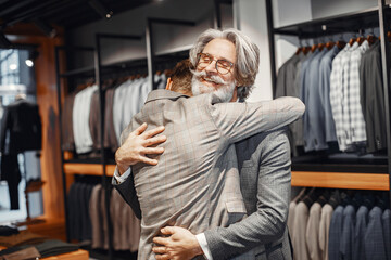 Senior man choosing a new suit in a store